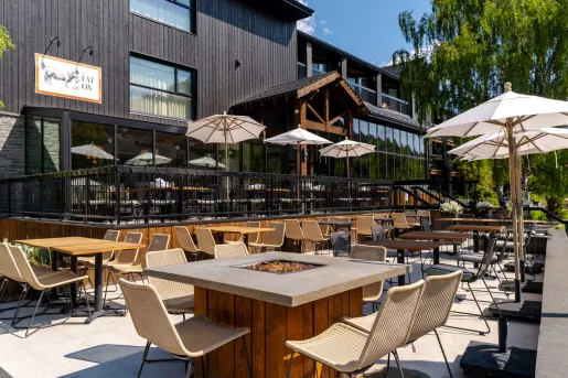 Outdoor patio with open fire pits and chairs around the area