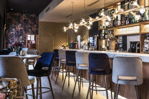Bar with tall stools in front of  a bar counter