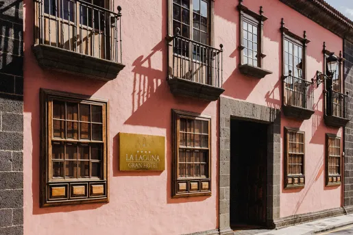 Exterior view of pink building with large windows