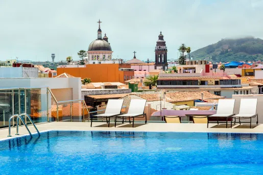 Outdoor, rooftop pool with a European town in the distance