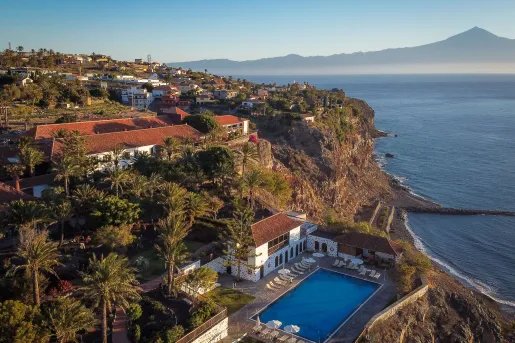 Exterior, sky view of buildings on a cliff with an outdoor pool