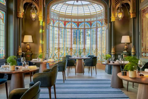 Restaurant dining area with large windows and cushioned chairs