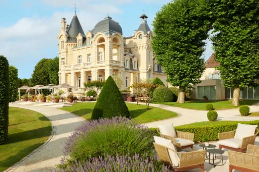 Garden with a large castle-like building in the background