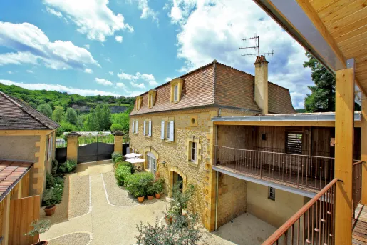 Exterior, 2nd-story view of a stone building with a large valley in the background