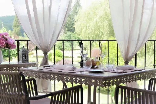 Outdoor patio with a dining table and gray steel chairs