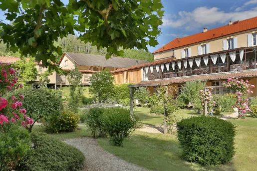 Exterior view of orange and yellow building with a garden in front