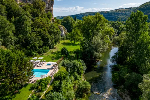 Sky view of large trees surrounding an outdoor pool