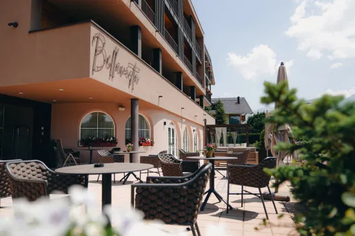 Outdoor patio next to a beige-colored hotel building