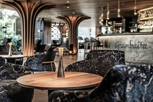 Hotel lobby with patterned, cushioned chairs and large pillars