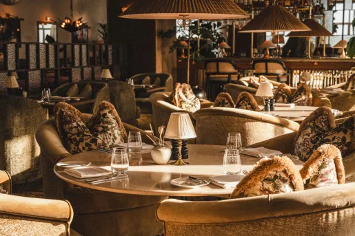 Indoor lounge with cushioned couches with circular tables