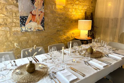 Restaurant dining table with a long white tables and wine glasses