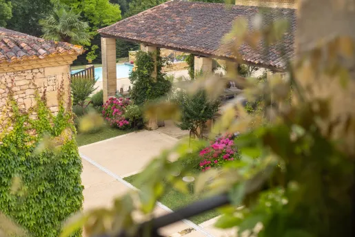 Sky view of stone building patio with a garden outside