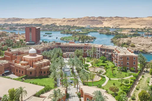 Aerial view of the historic complex of the Cataract Aswan nestled along the banks of the Nile.