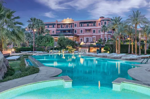 The large infinity swimming pool illuminated at dusk at the Old Cataract Aswan in Egypt.