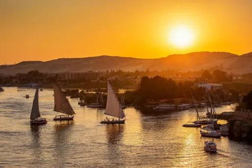Beautiful view on felucca boats on Nile river in Aswan at sunset, in Egypt.