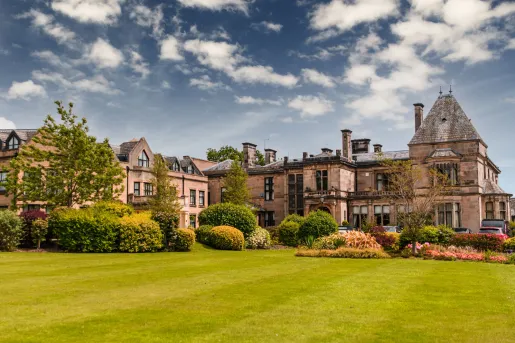 Exterior view of castle0like hotel building with a large lawn in front
