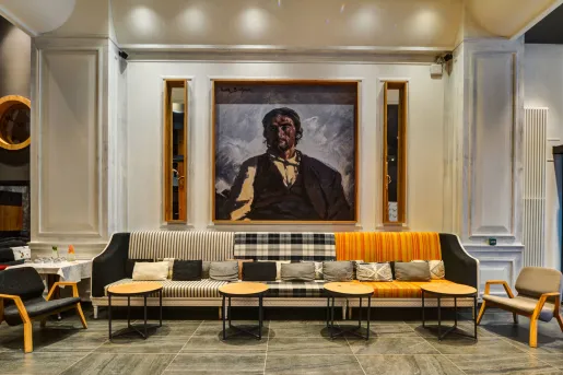 Long sofa in front of a large painting in a room