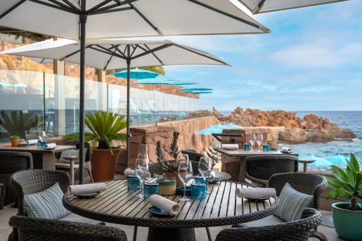 Outdoor patio with tables and views of the ocean