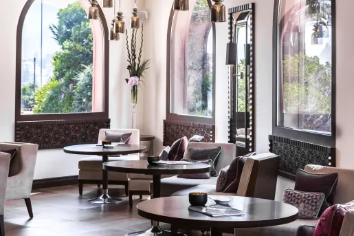 Hotel lobby with circular tables and cushioned chairs