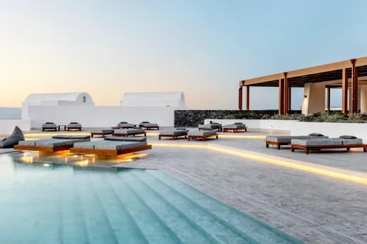 Pool with underlit loungers and clear water.