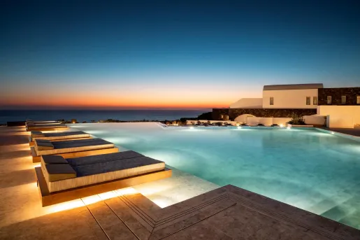 Infinity pool with loungers and the ocean on the horizon.