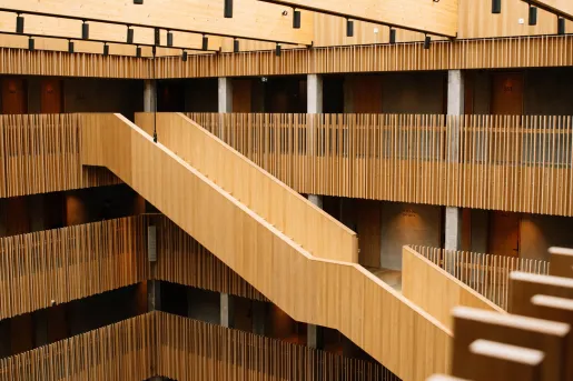 The modern interior of the KG Hotel in Klaksvík, Faroe Islands, which features a timber-clad staircase and acoustic slat walls.