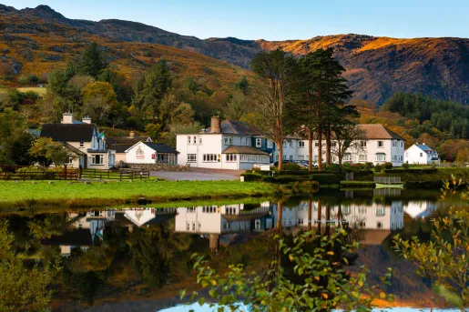 Exterior view of white buildings in front of a large lake