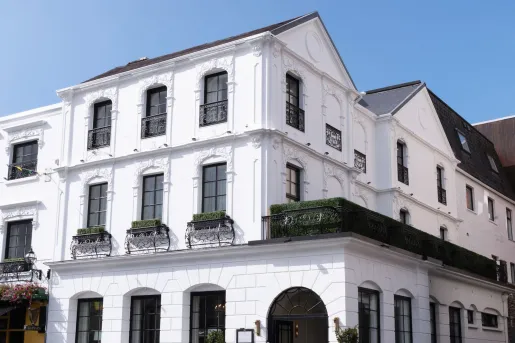 Exterior view of white and black building in the corner of a street