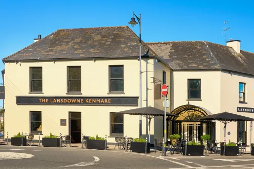 Exterior view of beige and gray building with a long road in front