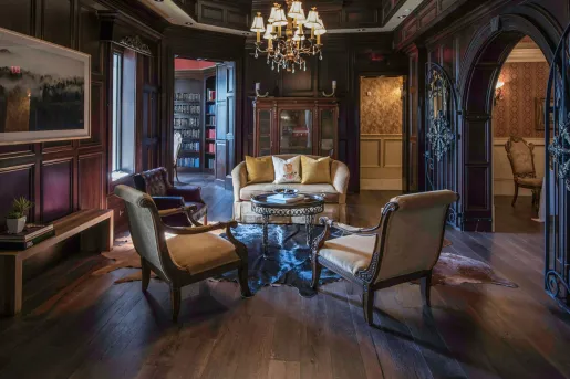 Large room with cushioned chairs and paintings on the walls