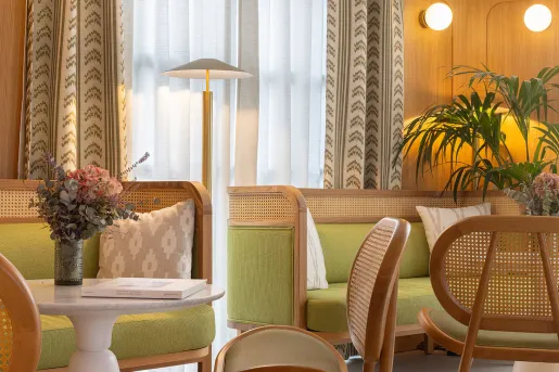Lounge and seating area with green chairs and couches