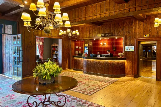 Hotel reception area with a circular table and two men standing behind the counter
