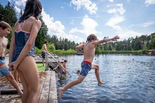 Kids jumping into a lake