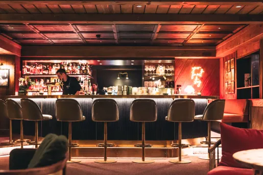 Bar and lounge with tall bar stools and dim lighting