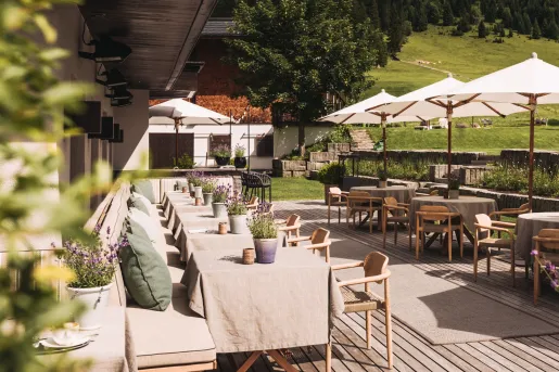 Outdoor patio with dining tables and white umbrellas