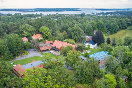 Sky view of a hotel complex in the middle of a large forest