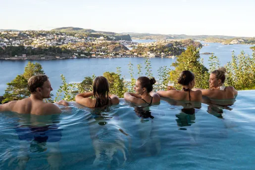 Group of men and women in a row, floating in a pool