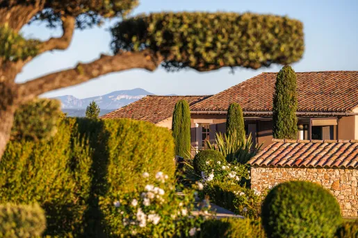 Lush Mediterranean landscaping with manicured hedges and cypress trees at Hôtel La Bastide Saint Georges.