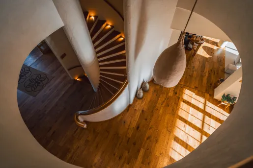 Top-down view of a staircase leading to a room with wooden floors