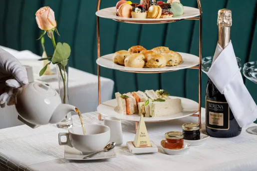 White table with a tea set and thrree-tier plate holder