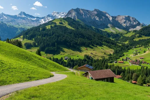 Long trail in a grassy hill with small cottages scattered throughout