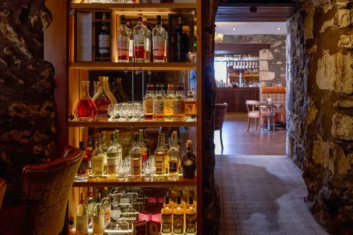 Underground cave with a shelve full of liquor bottles