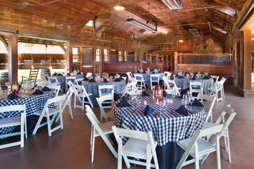 Restaurant dining hall with plaid-checkered tables and white chairs