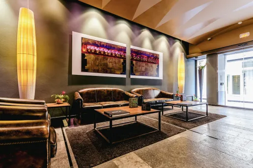 Leather sofas along a wall with stone flooring