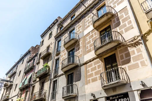 Exterior view of a multi-story, brick building with balconies