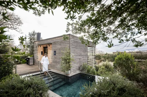 Outdoor spa with a person in a white robe