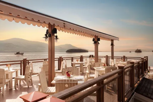 Outdoor patio and dining area with views of the ocean in the background