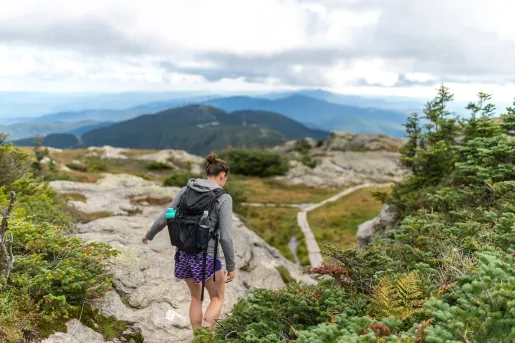 A hiker on rocky terrain in the Green Mountains of Vermont.