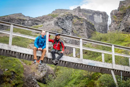 Iceland Ocean Cruise Walking & Hiking Tour - Two hikers sitting on bridge