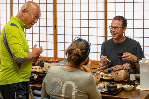 Man and woman eating in a traditional, Japanese room